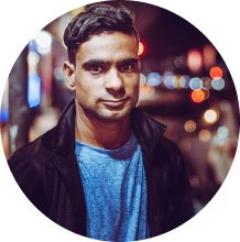 A man with city lights behind him